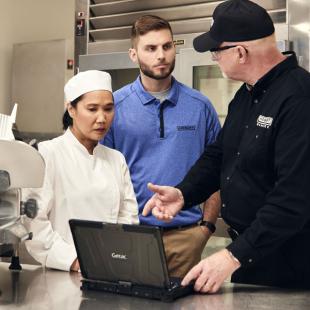 Hobart employees making a presentation to a restaurant chef on a laptop 